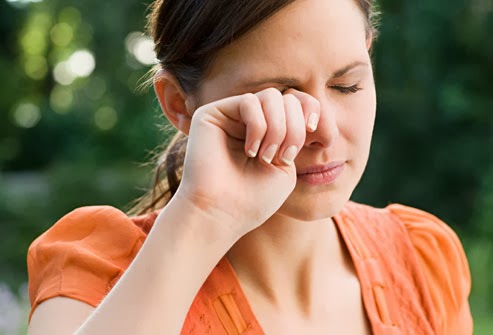<img alt="young woman rubbing her dry eyes"