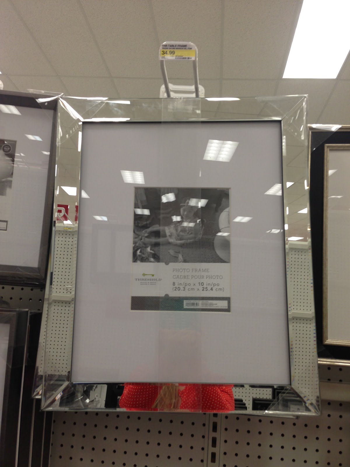 Mirrored picture frame from Target. Cluster 6 or 8 on a black wall see