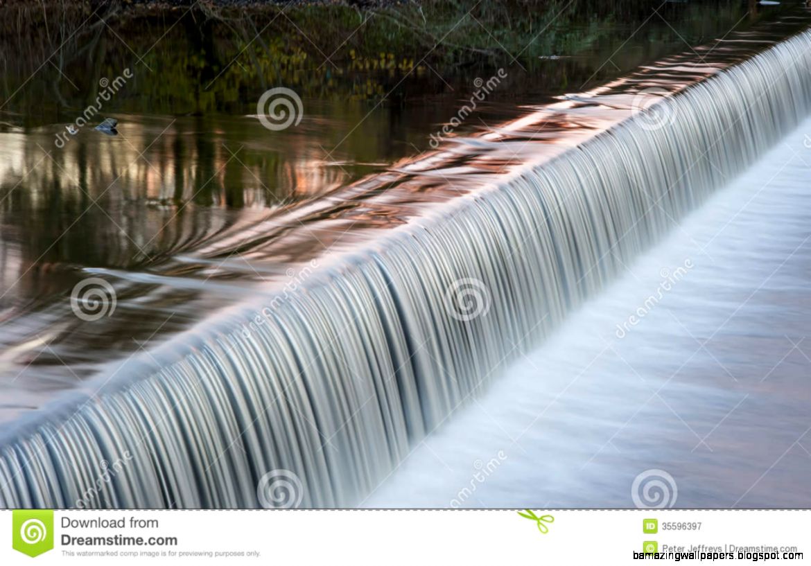 Flowing Water Cascading Over A Weir On Yorkshire River Stock Photo Flowing Water Cascading Over A Weir On Yorkshire River Stock Photo