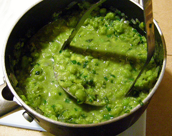 Using Potato Masher on Peas in Saucepan