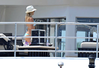 Kate Hudson in a blue and white bikini wearing a hat  