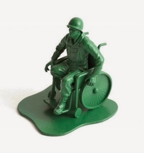 Green plastic army man in wheelchair