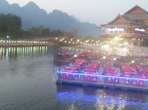 View of restaurant on banks of Nam Song river.