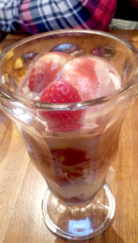 Sundae, scrummy sundae. A strawberry sundae dessert.