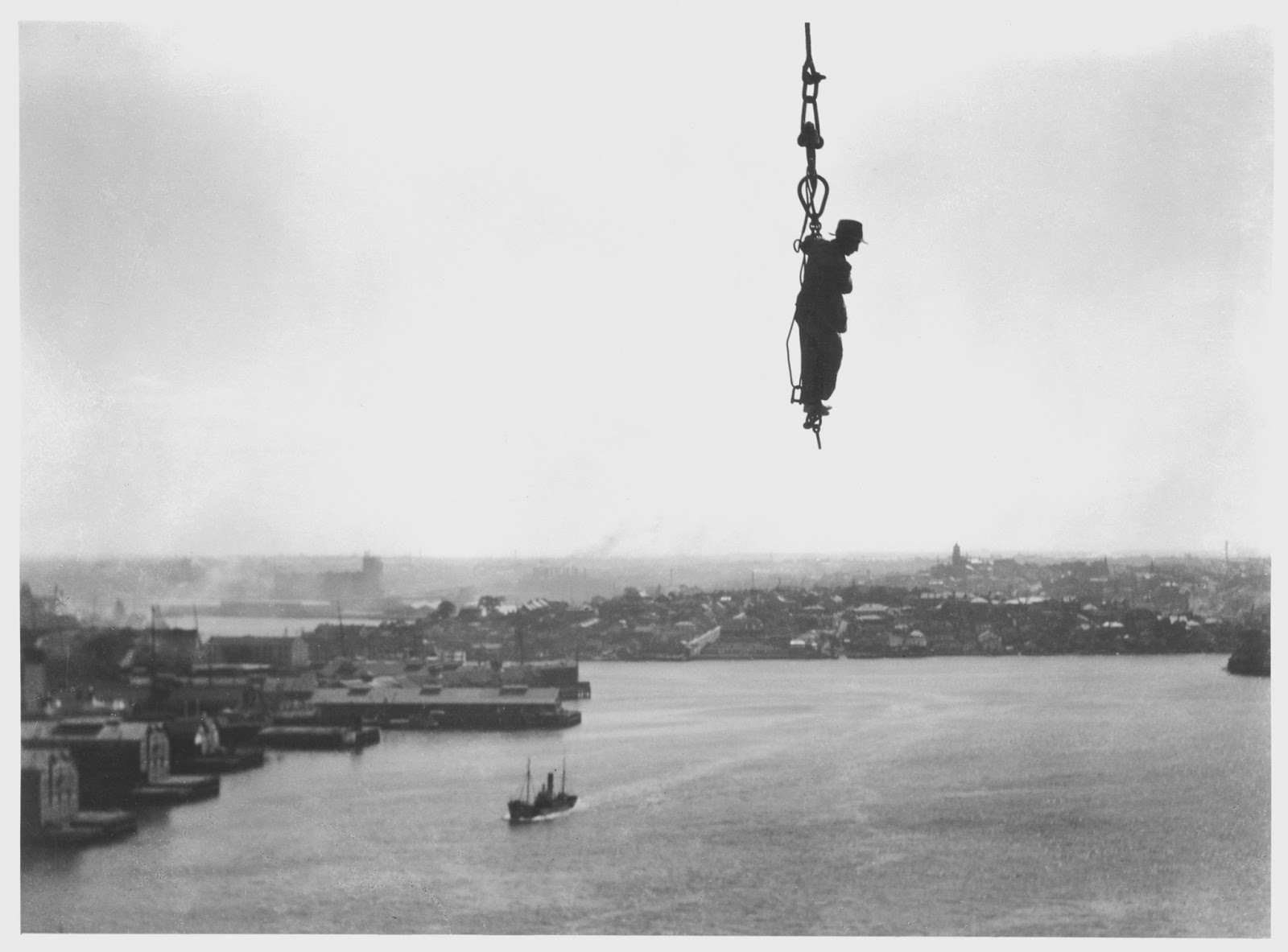 Construction worker dangles from a crane, 1930 vintage everyday