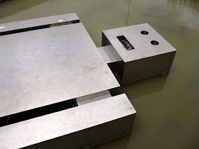 Ronnie van Hout's 'Fallen robot' sculpture of a metal robot in a pond.