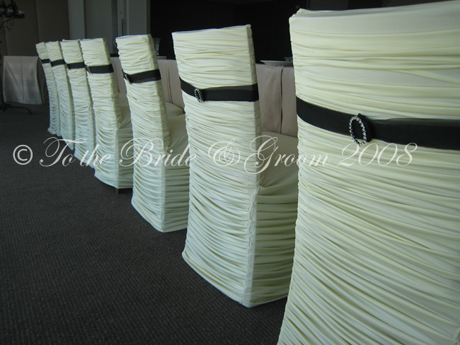 Our ivory designer fitted chair covers with black diamante band