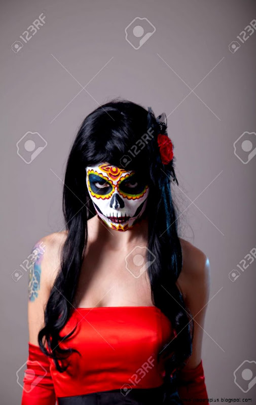 Young Woman With Sugar Skull Halloween Make up Wearing Red Dress Young Woman With Sugar Skull Halloween Make up Wearing Red Dress