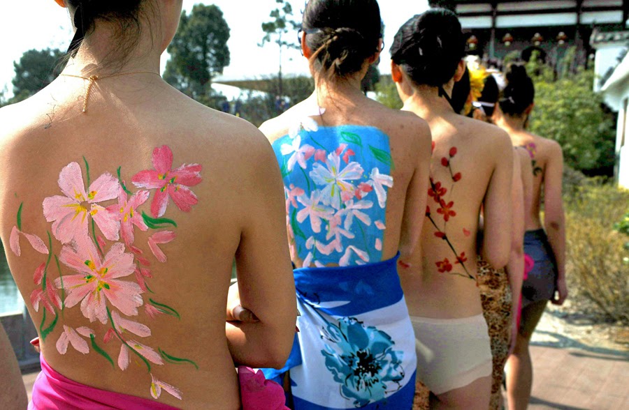 Half-naked models show off their body paintings of cherry blossoms at the P...