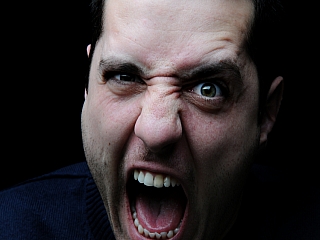 A man who is having anger problems makes an angry face A man who is having anger problems makes an angry face