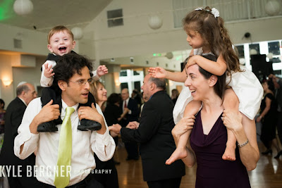 Kids on their parents shoulders at the reception