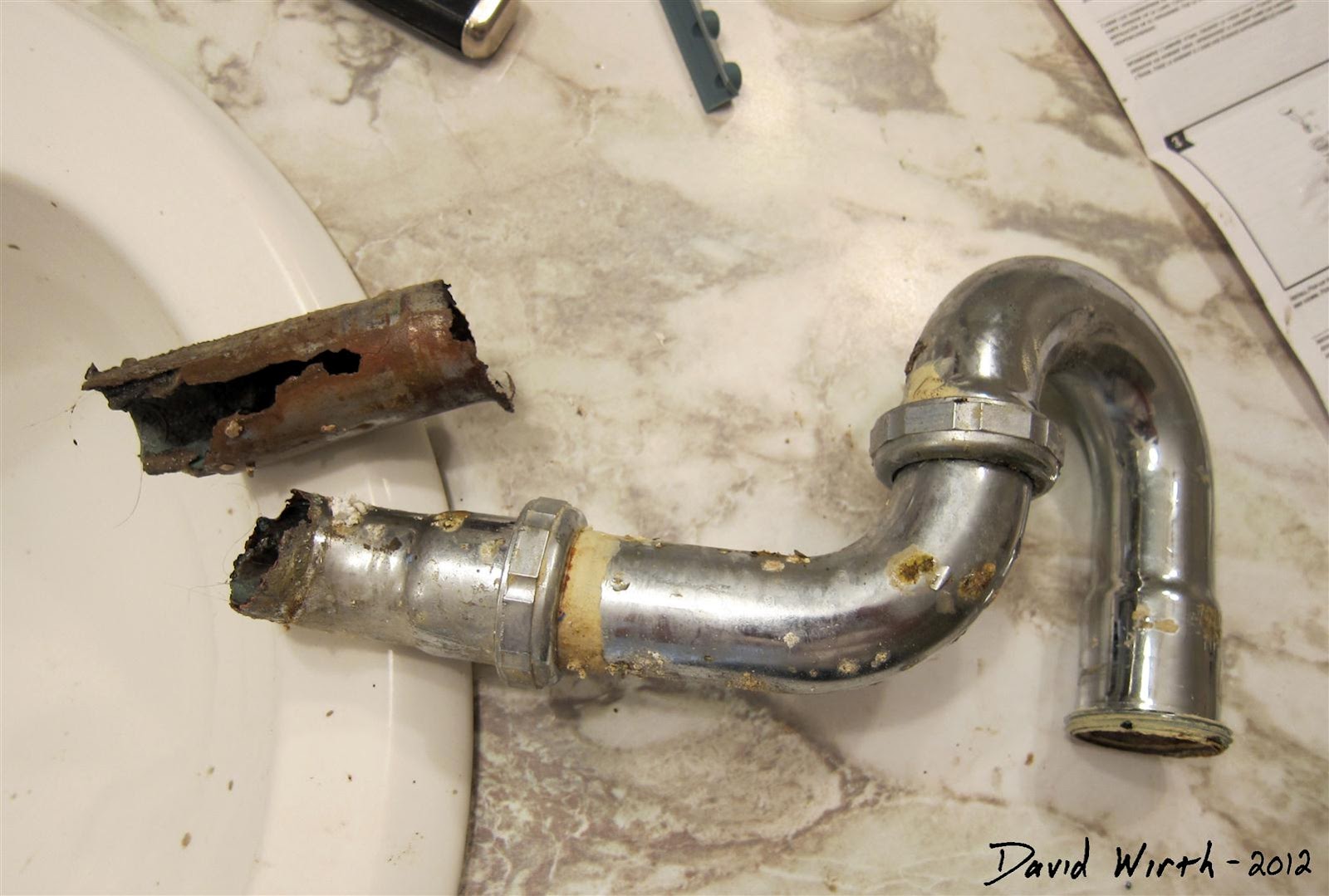 broken drain pipe under bathroom sink