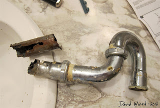 rusted, broken bathroom sink drain, metal pipe u bend