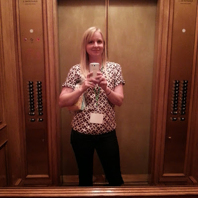 a woman taking a self portrait in an elevator mirror
