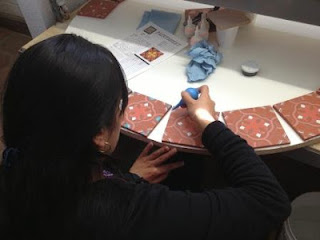 Tile artisan hand-glazing each piece Tile artisan hand-glazing each piece