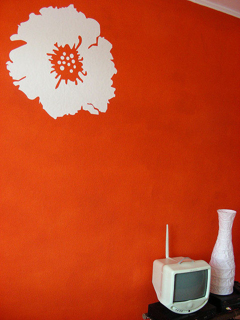 red wall with flower decal