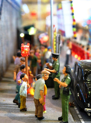Figures on a model Hong Kong street.