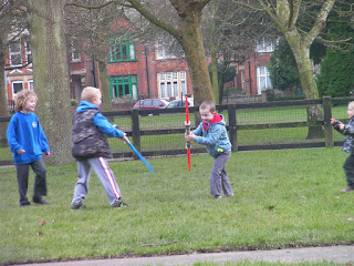 boys fighting with plastic light sabres