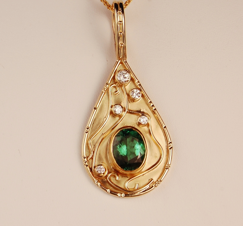 18k yellow gold pear shaped pendant with green stone and diamond accents