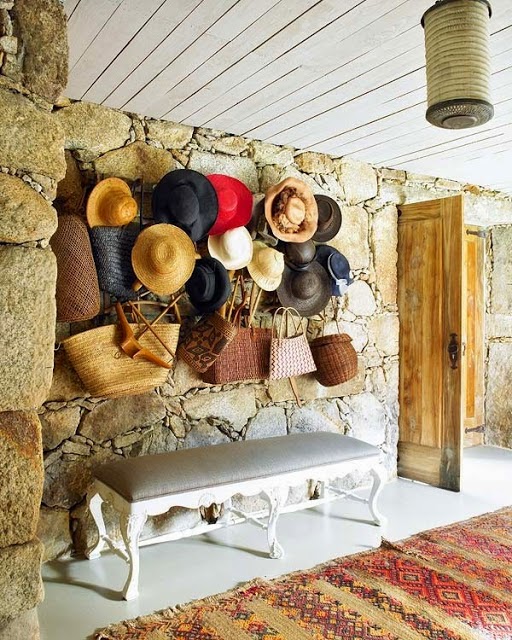 The Awesome hats and baskets on a rustic stone wall photograph