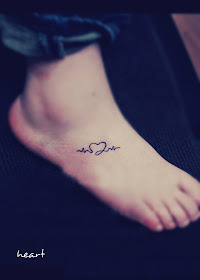 a heart tattoo on the foot formed by pulse type of curve