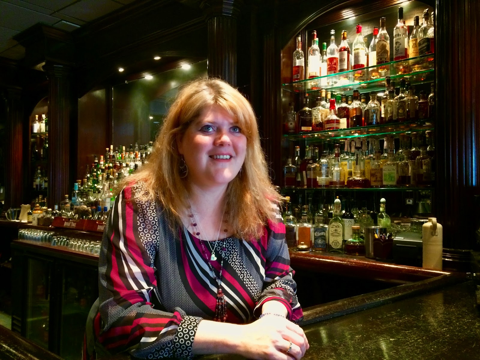 Brandi Lauck hanging out behind the bar while Arthur rambles on about whiskey
