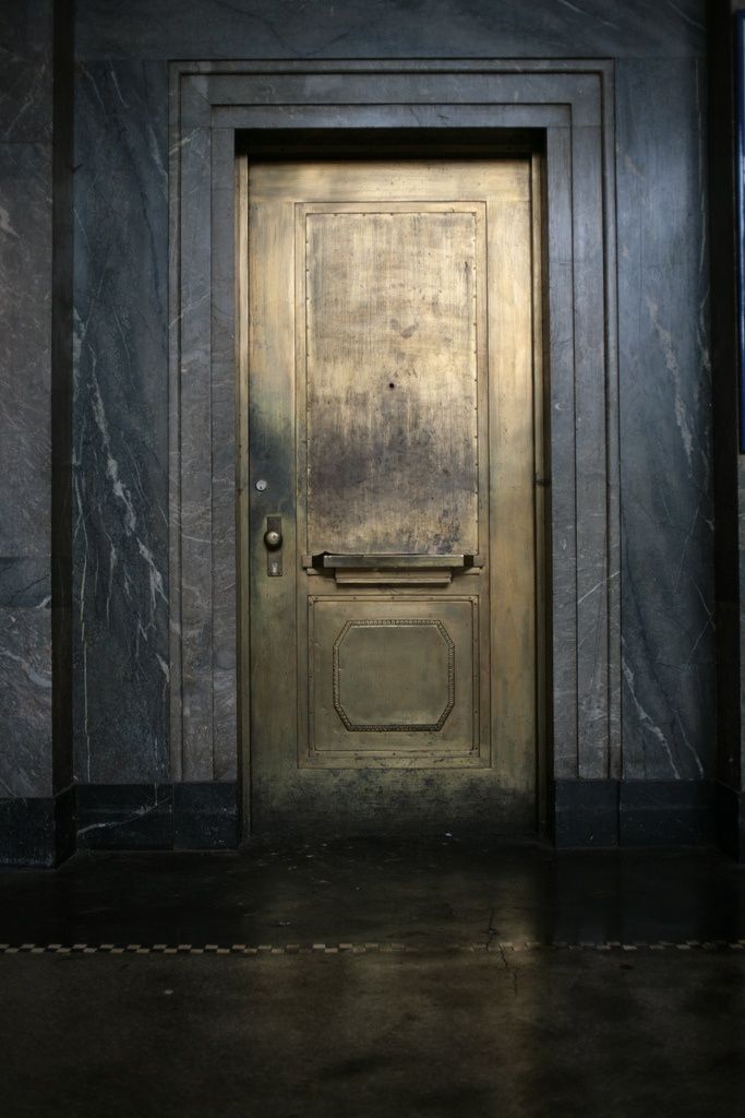 Black marble building with brass door