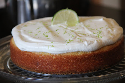 whole margarita cake topped with whipped cream and a slice of lime