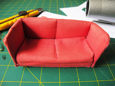 Lundby dolls' house sofa sitting on a workbench with tools in the background.