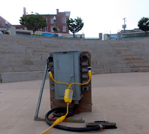 Our power source: a box from a truck wired into the ground-literally. Town mural at top of  steps.