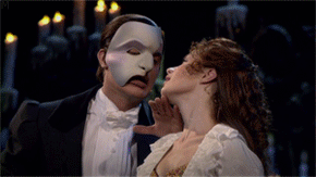 Animated gif of the Phantom from Phantom of the Opera following a flying box of Pizza Rolls