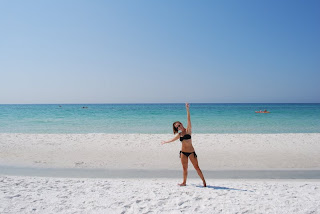 Caitlin Houston standing in black bikini on Beach at Luxury Destin Florida Penthouse Condo