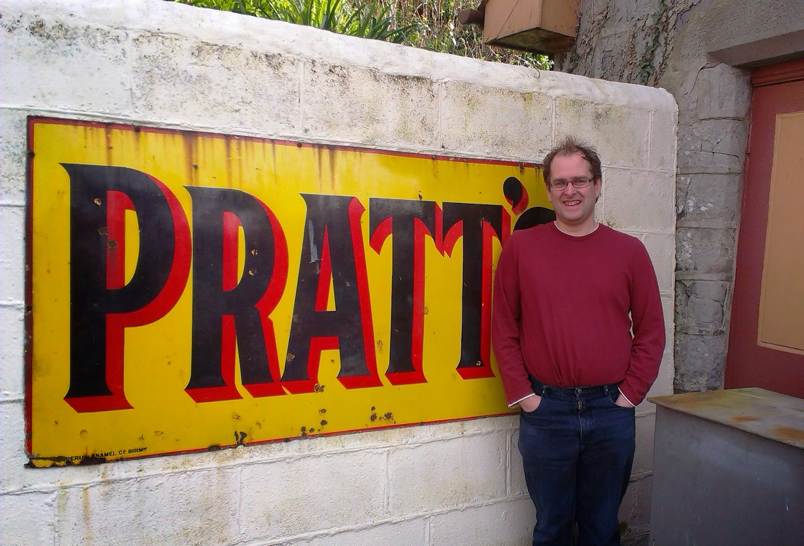 Andrew in front of a vintage Pratt's sign