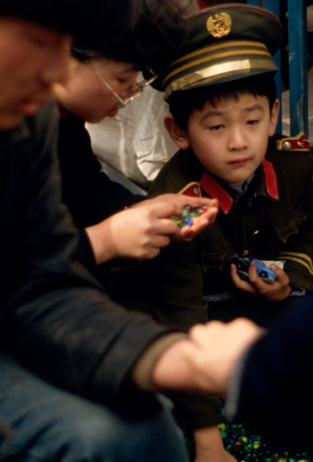 "Child Soldier Losing His Marbles", Beijing, China 1990 by Karin Lisa Atkinson