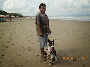 A handicapped  pet mongrel with its owner on Kuta beach.