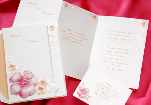 Groups of hot pink and tangerine hibiscus grace this bright white invitation