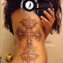 Elaborate cross tattoo on side body 