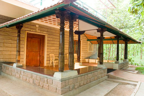 Anand Dham with its stepped Mangalore-tiled roofing nestled amidst nature