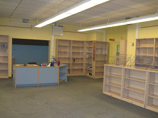 Librarian's desk and empty bookshelves