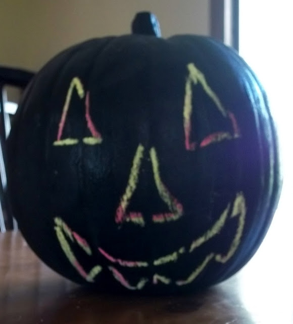 Make a Plastic Pumpkin Painted with Chalkboard Paint.