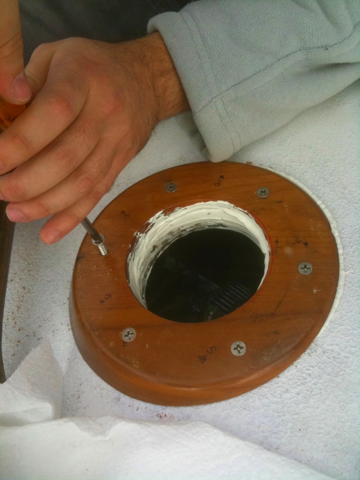 drilled out hole in teak winch pad