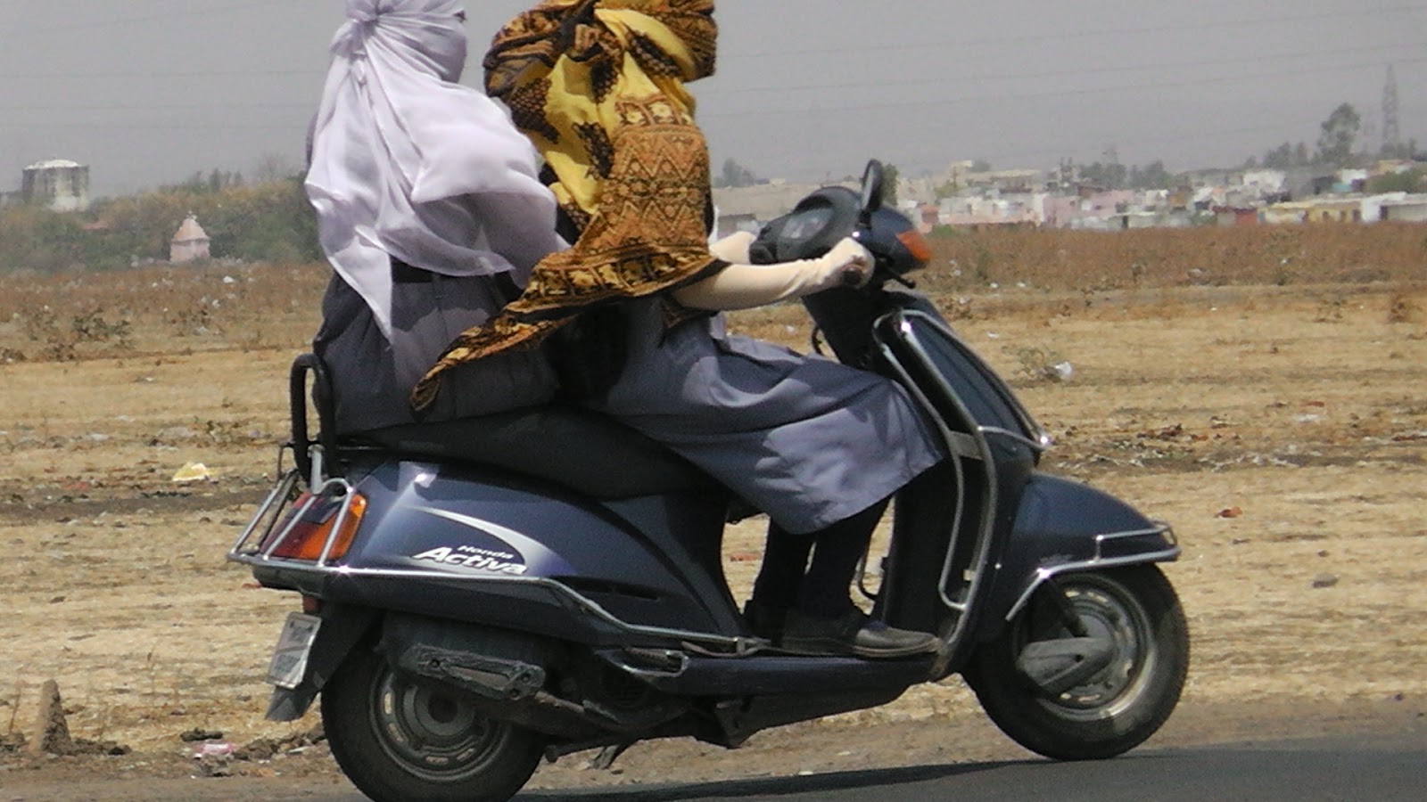 Daemon's Indian women in gloves, Indian women riding scooty