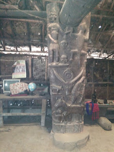 Carvings on main wooden support beam of the Wangnao Konyak hut.