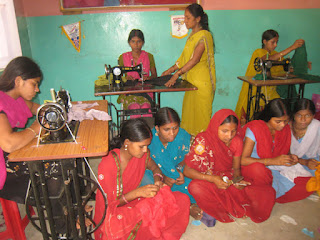 Nine women at the KIRF Sewing Center in India
