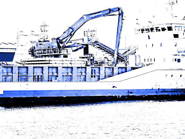 Cargo ship (being loaded with sand) adjusted into shades of blue and white.