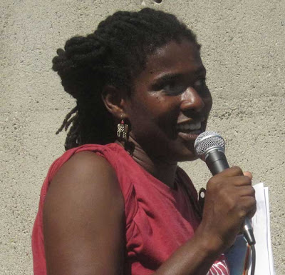 Tracine Asberry with microphone, speaking
