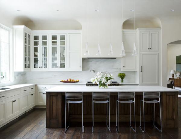 Surrounded by a white kitchen,