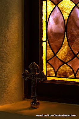 Stained glass window and small brass Cross.