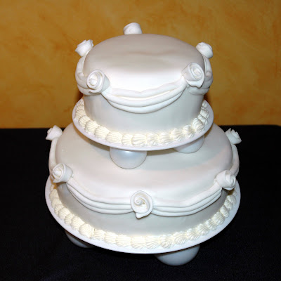 2 Tiered Wedding Cake Covered in fondant with fondant decorations