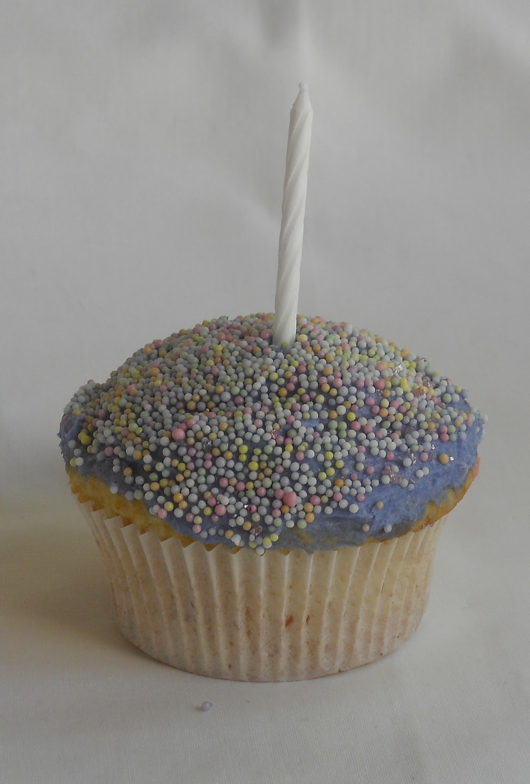 Sprinkles and Sparkles Pastel sprinkles on purple icing